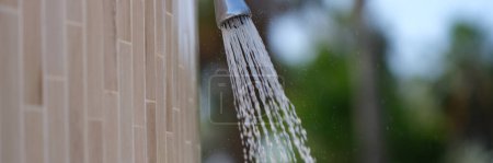 Photo for Detail of outdoor water shower on beach. Water pouring from the shower on the street concept - Royalty Free Image
