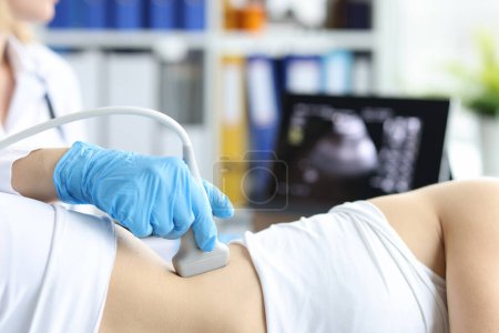 Photo for Doctor examines patient with prolapse of left kidney and spleen using ultrasound probe. Ultrasound diagnostics of soft tissues and organs concept - Royalty Free Image