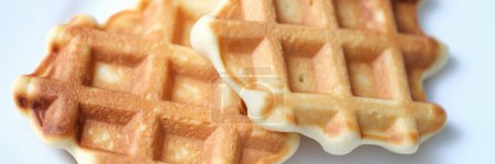 Photo for Two freshly baked Belgian waffles on white plate. Recipe dough for Belgian waffles concept - Royalty Free Image
