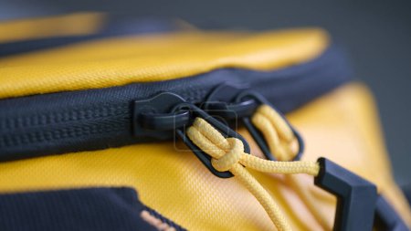Photo for Yellow and black zipper on sports backpack closeup. Accessories for sewing bags concept - Royalty Free Image