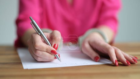 Photo for Female hands in metal handcuffs writing explanatory note closeup. Court detention law concept - Royalty Free Image