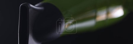 Téléchargez les photos : Green hair dryer with flat nozzle on black background. Types of nozzles for hair dryers functions and use concept - en image libre de droit