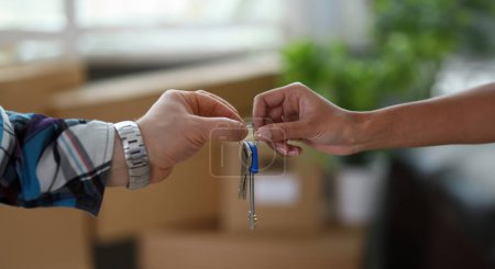 Photo for Close-up of male and female hands with keys from new house. Couple holding keychain. Purchase apartment, relocation and changing of living place concept - Royalty Free Image