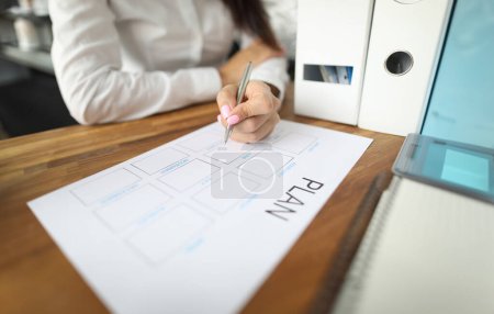 Photo for Woman draws up paper financial payment boards. Account grouping and cash flow analysis. Multilevel structure categories and projects. Consolidate finances balance for reporting period - Royalty Free Image