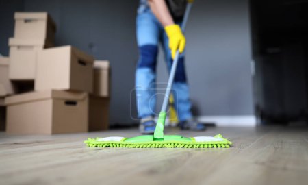Photo for Close-up of male hands holding microfiber fluffy rag and mopping floors. Cleaning apartment after moving or renovation. Housework and spring-cleaning concept - Royalty Free Image