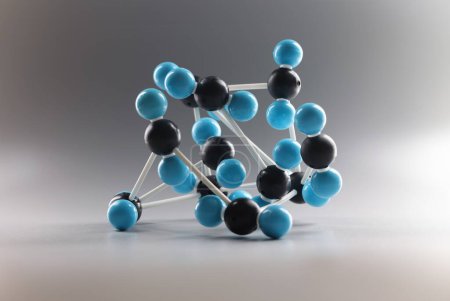 Téléchargez les photos : Gros plan de la structure du modèle moléculaire, miniature sur fond gris, cellules bleues et noires reliées entre elles. Laboratoire, chimie, concept scientifique - en image libre de droit
