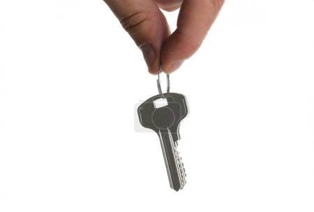 Photo for A male hand holds a metal bunch of keys from the apartment door isolated on a white background - Royalty Free Image