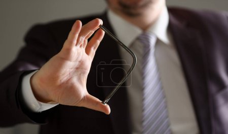 Photo for Man in suit and tie bend nail with arms closeup no limit energy easy problem solve issue superman help pressure concept - Royalty Free Image