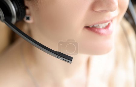 Photo for Closeup of black head set on woman head. Psychological assistance by phone concept - Royalty Free Image