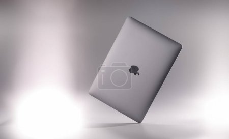 Foto de TBILISI, GEORGIA - 6 DE DICIEMBRE DE 2024: nuevo portátil digital Apple MacBook aire sobre fondo gris primer plano. Venta de equipos informáticos y concepto electrónico - Imagen libre de derechos