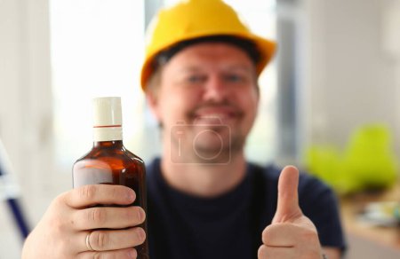Photo for Arm of drunken worker in yellow helmet show OK gesture or confirm sign with thumb up closeup. Manual job workplace DIY inspiration fix shop hard hat industrial education profession career - Royalty Free Image