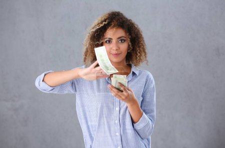 Beautiful black woman portrait. Scattering money notes dollars in fashion vows style curly hair with white locks eye view of the camera