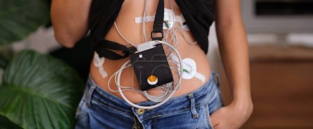 24-hour ECG monitoring and Holter monitoring on a woman body. Cardiac examination and heart health
