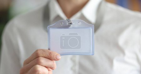 Photo for Woman holding blank badge in hand closeup. Personal identification at business conferences concept - Royalty Free Image