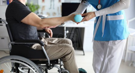 Photo for Female nurse helps lift dumbbell to disabled patient rehabilitation therapy concept. Process of recovering patients after severe injuries - Royalty Free Image