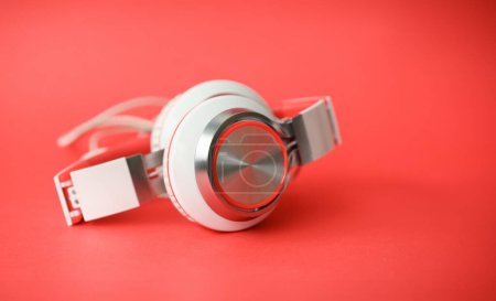 Photo for White modern headphones on coral background concept - Royalty Free Image