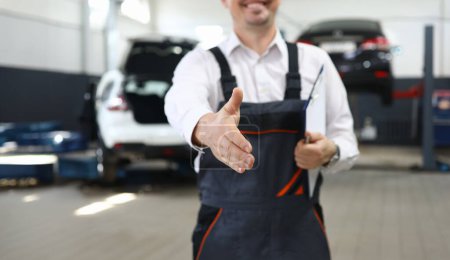 Photo for Focus on smart man hand reaching for firm handshake with someone and holding important paper folder with information about different autos. Machinery repairman concept - Royalty Free Image