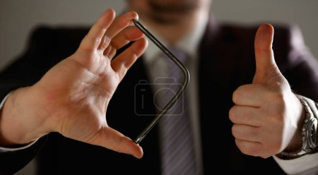 Photo for Man in suit and tie bend nail with arms closeup no limit energy easy problem solve issue superman help pressure concept - Royalty Free Image