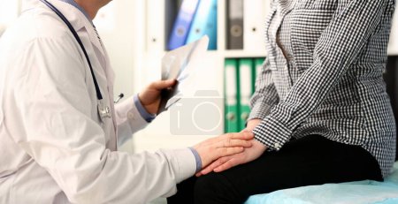 Photo for Clinic Doctor with X-ray Image Hold Patient Hand. Physician with Stethoscope Support Sick Woman. Health Examination in Hospital. Female Visit Medic Specialist. Healthcare Therapy Lifestyle - Royalty Free Image