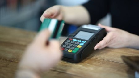 Photo for Cashier Hand Taking Plastic Credit Card to Payment. Electronic Money Transaction via Bank Terminal. Commerce Machine for Online Financial Operation. Using Technology Device Close-up Photography - Royalty Free Image