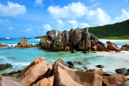 Photo for Anse Cocos beach with big granite stones in La Digue Island, Indian Ocean, Seychelles. Tropical landscape with sunny sky. Exotic travel destination. - Royalty Free Image