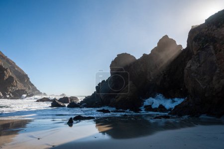 Late afternoon impression of Pfeiffer beach, California on a bright sunny afternoon as the sun is about to set.
