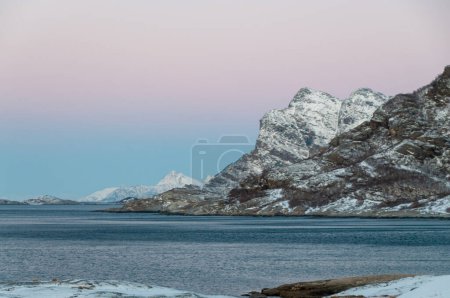 Photo for Telephoto shot of the rugged norwegian coastline near Mjelle in the Arctic, during a brief golden hour. - Royalty Free Image