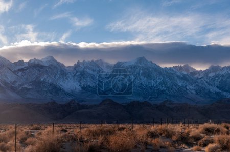 Photo for The towering mountains of the Sierra Nevada form a backdrop of the road to Lone Pine, California. - Royalty Free Image