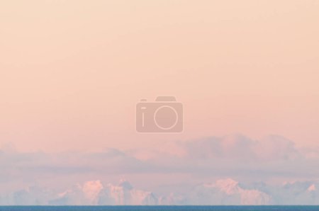 Photo for Telephoto shot of the snow-covered mountains of the Lofoten, as seen from the Norwegian mainland, near the town of Bodo. - Royalty Free Image