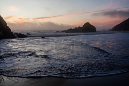 Photo for Water from the pacific ocean washing ashore on Pfeiffer beach, around sunset. - Royalty Free Image