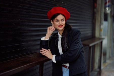 Photo for Woman smile with teeth tourist walks walks in the city studying the history and culture of the place, stylish fashionable clothes and make-up, spring walk, travel. High quality photo - Royalty Free Image