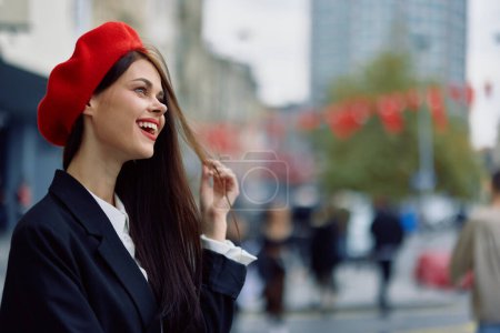 Photo for A beautiful smile woman with teeth walks in the city against the backdrop of office buildings, stylish fashionable vintage clothes and makeup, autumn walk, travel. High quality photo - Royalty Free Image