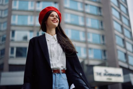 Photo for A business woman walks in the city against the backdrop of office buildings, stylish fashionable vintage clothes and make-up, spring walk, travel. High quality photo - Royalty Free Image