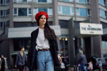 Photo for A business woman walks in the city against the backdrop of office buildings, stylish fashionable clothes and make-up, spring walk, travel. High quality photo - Royalty Free Image