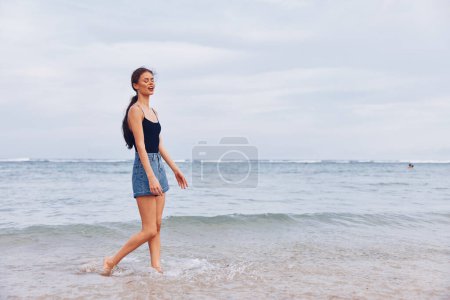 Photo for Woman water sunset beach long young smiling summer running lifestyle sand sexy sunrise carefree smile fun nature happiness person travel hair sea - Royalty Free Image