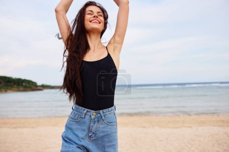 Photo for Water woman flight lifestyle summer hair young running hair smile long bikini travel sea tan vacation sunset wave beach relax leisure happiness - Royalty Free Image