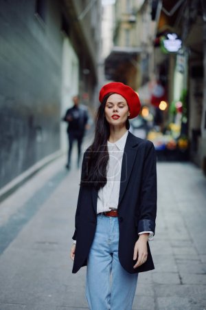 Photo for Fashion woman portrait walking tourist in stylish clothes with red lips walking down narrow city street, travel, cinematic color, retro vintage style, dramatic. High quality photo - Royalty Free Image