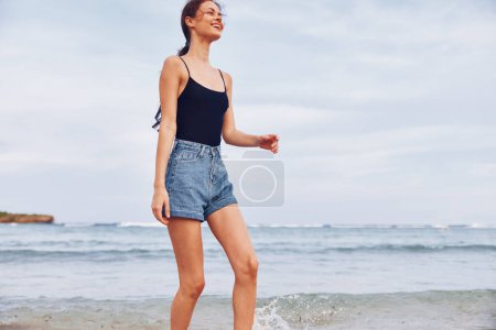Photo for Young woman smiling running lifestyle beach summer sea relax person girl fun smile beauty leisure sunset sun travel female sand flight - Royalty Free Image