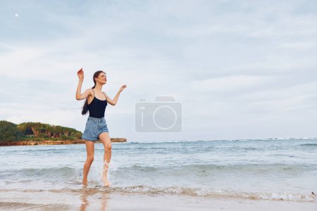 Photo for Happiness woman sea sun summer water nature sand hair sunset running travel relax lifestyle sunrise long female beach freedom flight young smile - Royalty Free Image