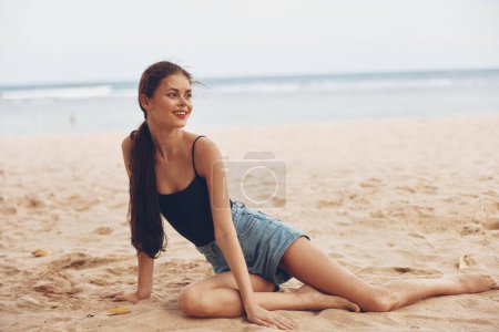 Photo for Young woman travel sexy pretty sea beach alone adult smile outdoor tan fashion sand freedom summer nature sun water sitting vacation - Royalty Free Image