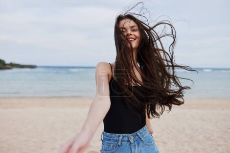 Photo for Woman hair beach vacation young freedom summer active activity wave running flight female sunset lifestyle smile walking travel sea beautiful person - Royalty Free Image