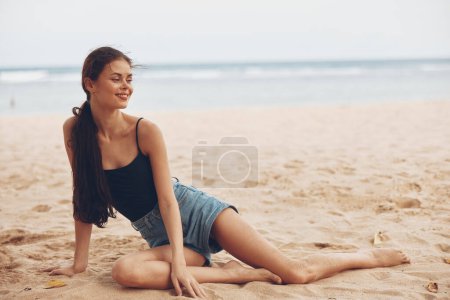 Photo for Sea woman natural travel water ocean alone adult sand long sitting beach young freedom relax person fashion hair smile vacation nature tropical - Royalty Free Image
