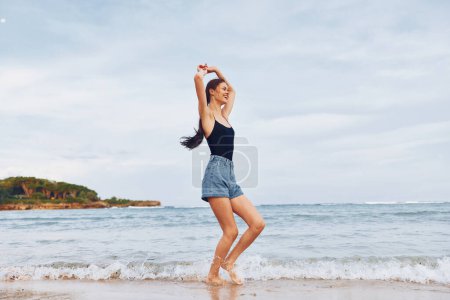 Photo for Lifestyle woman relax ocean freedom bikini smile beach young sunset vacation tan running wave flight travel nature female sea carefree summer - Royalty Free Image