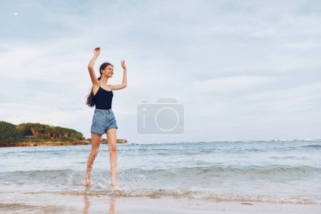 Photo for Body woman young running walking smile water lifestyle happy sea shore leisure travel vacation positive beach flight summer happiness sunset nature - Royalty Free Image