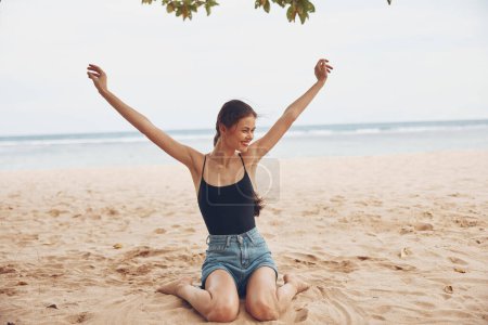 Photo for Tan woman summer smile vacation young nature water adult bali back tropical sitting freedom female carefree beach sea model view sand travel - Royalty Free Image