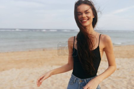 Téléchargez les photos : Coucher de soleil femme océan vacances plage vacances sable bonheur tropical insouciant caucasien été extérieur mer promenade sourire relax fille sourire liberté style de vie - en image libre de droit