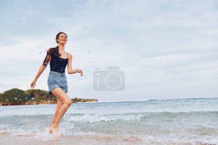 Photo for Woman smiling hair sunset bikini female space smile lifestyle copy long flight summer shore sand sea young running body beach travel person walking - Royalty Free Image