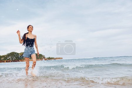 Photo for Woman travel young carefree beautiful flight sunset sexy beach shore smile water positive sunrise beauty lifestyle running happy sea summer girl - Royalty Free Image