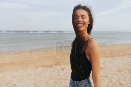 Photo for Woman sea beach adult hair summer beautiful sunset happy walk tropical happiness sand coast nature lifestyle smile copy-space ocean long vacation relax - Royalty Free Image