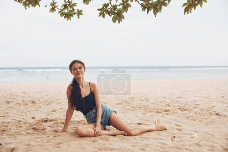 Photo for Woman smile sea beach lifestyle alone vacation attractive happy natural relax freedom nature tan sitting beautiful hair travel caucasian outdoor sand - Royalty Free Image